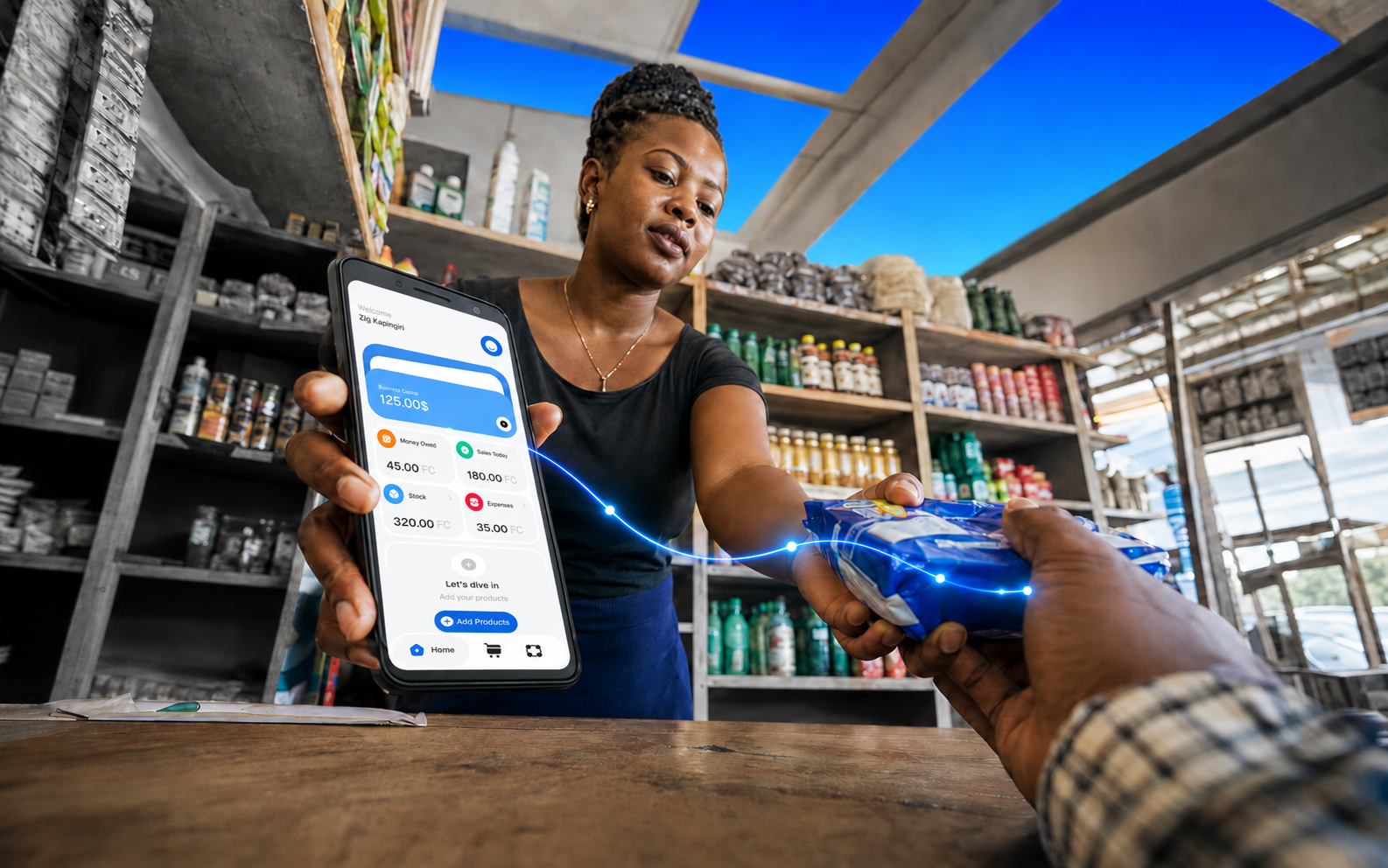 A shop owner completing a sale with a customer at the counter